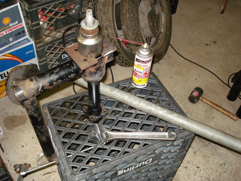 U-joint carrier bearing removal: The set up ready to go in the swing arm. I used two pieces of 1⁄4 inch plate steel to space the big socket at the swing arm hole, so I wouldn't be heating the whole rig.