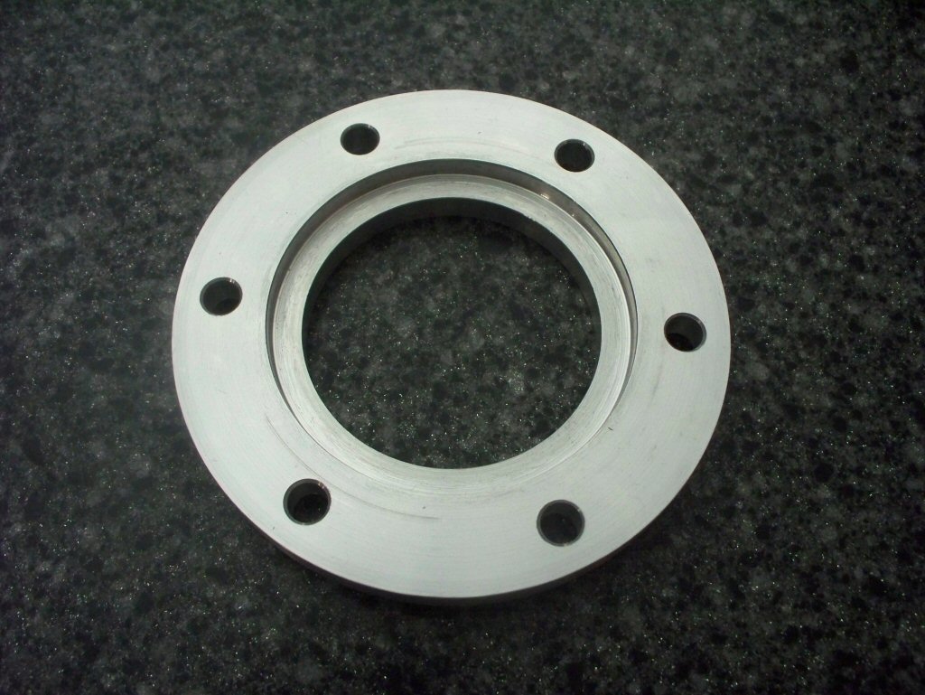 Disc brake spacer as used to fit a disc brake to drum brake Moto Guzzi V700, V7 Special, Ambassador, 850 GT, 850 GT California, Eldorado, and 850 California Police motorcycles.Spacer made by Joe Kenny.