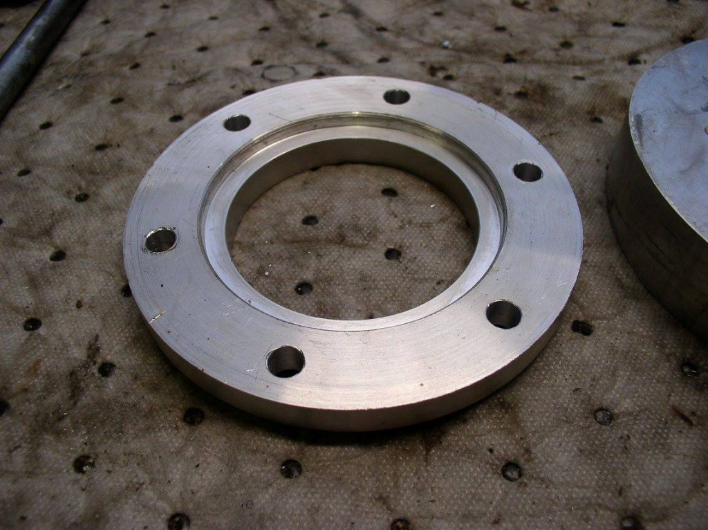 Disc brake spacer as used to fit a disc brake to drum brake Moto Guzzi V700, V7 Special, Ambassador, 850 GT, 850 GT California, Eldorado, and 850 California Police motorcycles.Spacer made by Charlie Mullendore of Antietam Classic Cycle.